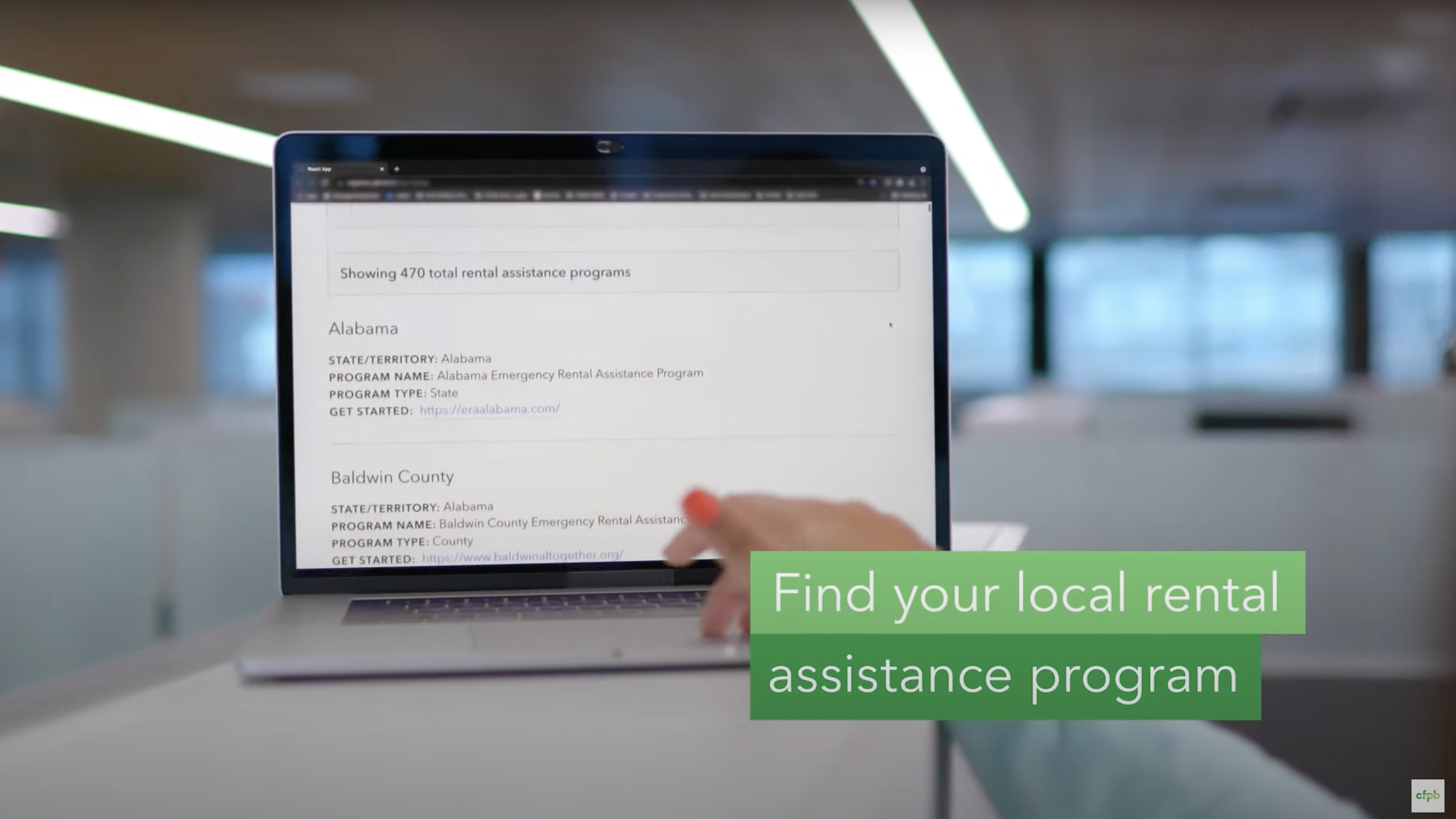 Footage of computer with the text "Find your local rental assistance program" in the lower third of the screen on a green box